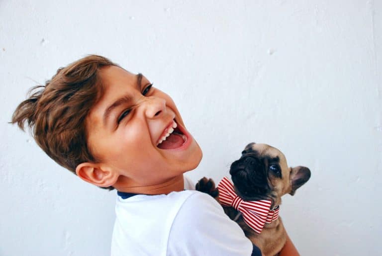 Kid smileing with dog