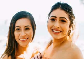Two women on beach smiling